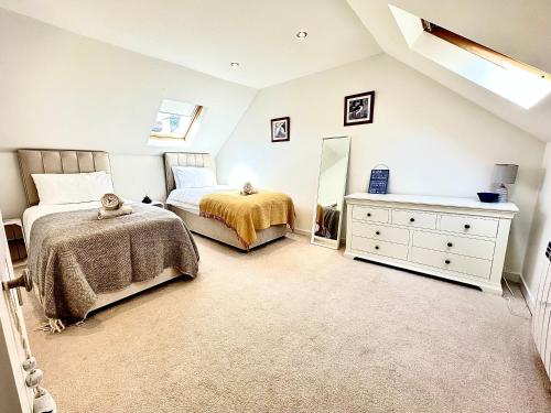 a bedroom with a bed and a dresser and a mirror at Luxury Smugglers Cottage in the Heart of Inveraray Sleeps 4 in 2 Bedrooms in Inveraray