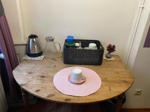 a table with a cup and a plate on it at Pension Jeske Heidelberg in Heidelberg