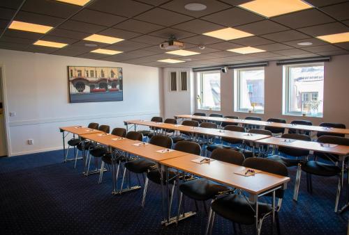 a room with rows of tables and chairs at Home Hotel Drott in Karlstad