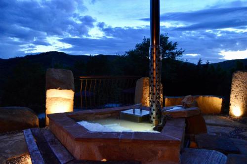 a hot tub on a patio at night at Agriturismo La Contessa Quarter Horse in Gubbio