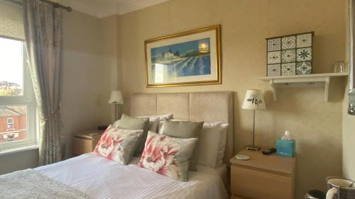 a bedroom with a bed and a window at St John's Guest House in Weymouth