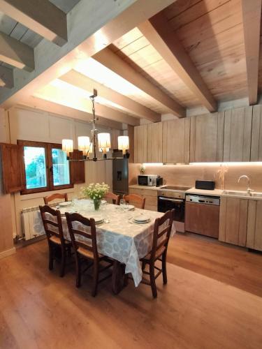 a kitchen with a table and chairs in a room at Turisme Rural Ca l'Axai casa 2 in Pi