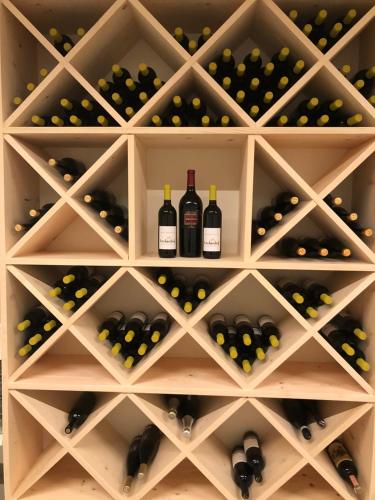 a wine cellar with wine bottles and grapes at Forchnerhof Panorama - App 3 Täler Blick in Rodengo