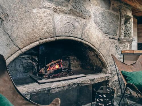 a stone oven with a fire inside of it at La grange du hameau in Saint-Lary-Soulan