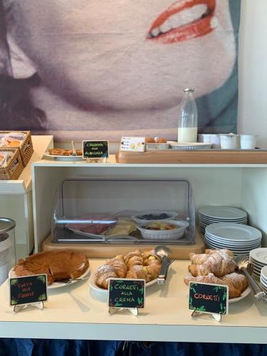 a display case with various pastries and other food items at Hotel Sole E Mare in Lido di Camaiore