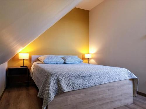 a bedroom with a bed with two lamps on it at La grange du hameau in Saint-Lary-Soulan