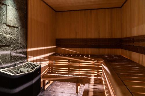 a sauna with two wooden benches in a room at Marstrands Kurhotell in Marstrand