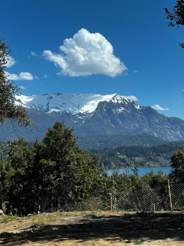 a view of a mountain range with a body of water at Casa Silente in San Carlos de Bariloche