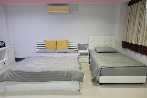 Voodi või voodid majutusasutuse Kaewchantra Mansion toas