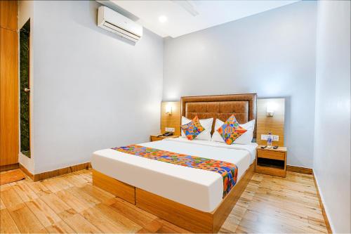 a bedroom with a large bed in a room at FabHotel Zara Grand in Mumbai