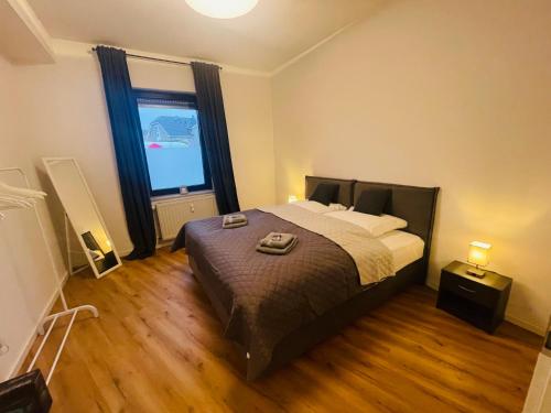 a bedroom with a large bed and a large window at modern * gemütlich * Nespresso * Terrasse * Netflix in Duisburg