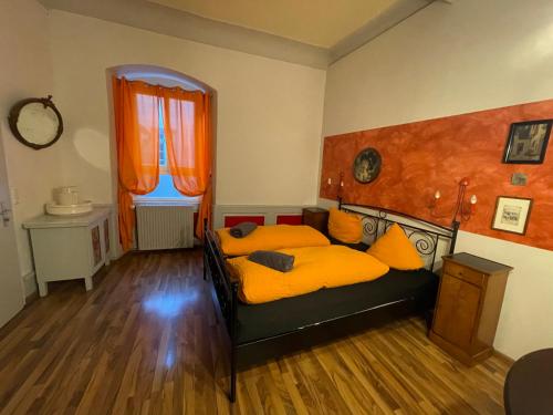 a bedroom with a bed with yellow pillows at Pension Jeske Heidelberg in Heidelberg