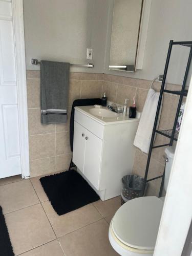a bathroom with a white sink and a toilet at bedroom private in Miami
