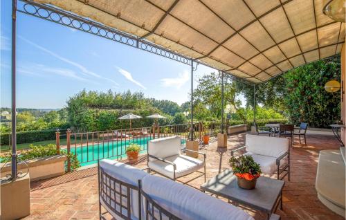 an outdoor patio with a view of a pool at 8 Bedroom Beautiful Home In Fucecchio in Fucecchio