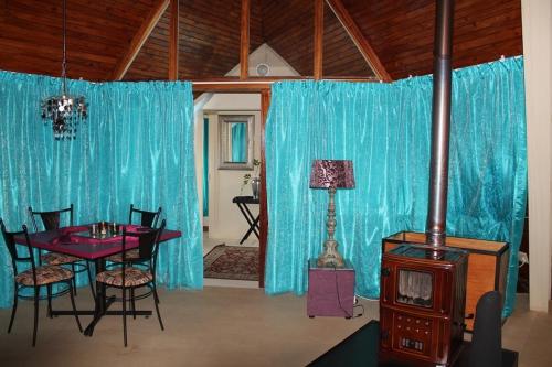 a living room with a table and a stove at Pyramids Motel in Van Reenen
