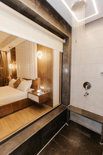a hotel room with a bed and a mirror at Ramage Hotel & Resort in Cairo