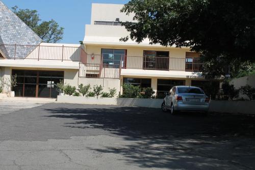a car parked in front of a building at Pyramids Motel in Van Reenen