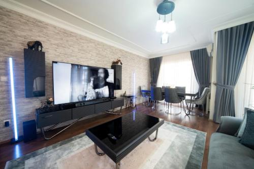 a living room with a large flat screen tv at Saygın Apartments in Istanbul