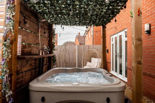 a jacuzzi tub in the backyard of a house at Spacious & Stylish 4-Bed House with Hot Tub in Prime Location in Southampton