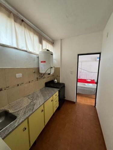 a kitchen with a sink and a microwave in it at Hotel 4 Ases in Embalse