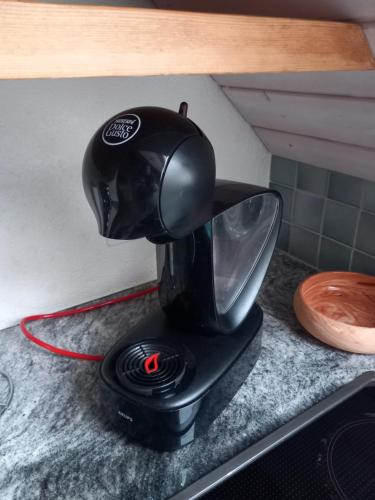 a black mixer on a counter with a red cord at Bright, sunny holiday apartment on the farm 