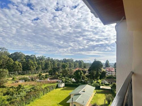 a view from a balcony of a house with a yard at Luxurious 2 bedroom penthouse-Fully Furnished in Kitale
