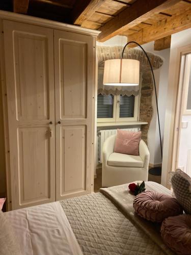 sypialnia z łóżkiem, krzesłem i lampką w obiekcie The Key Of Bergamo w Bergamo