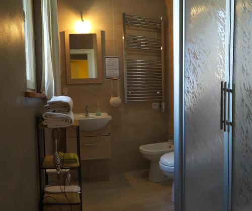 a bathroom with a toilet and a sink and a mirror at Agriturismo La Dependance in Sorano