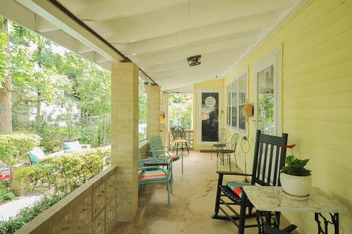 a porch with chairs and tables on a house at House Near Bju, Furman, & Town in Greenville