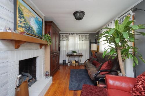 a living room with a couch and a fireplace at House Near Bju, Furman, & Town in Greenville