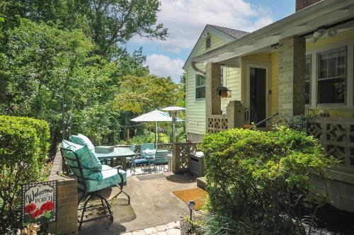 a patio with a table and chairs next to a house at House Near Bju, Furman, & Town in Greenville