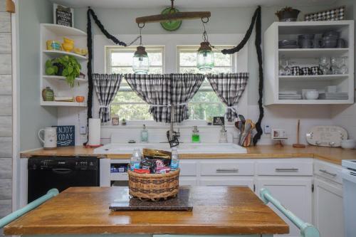 a kitchen with a table with a basket on it at House Near Bju, Furman, & Town in Greenville