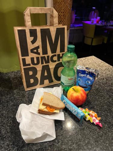 a sandwich and an apple and a bottle of water at Am Obersee Hotel in Simmerath