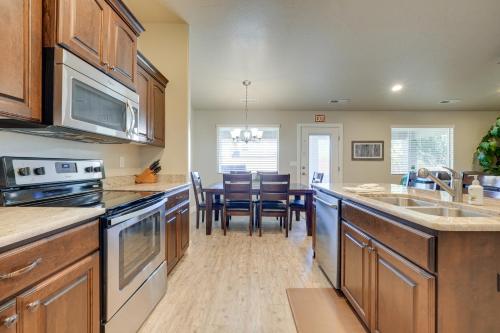 a kitchen with wooden cabinets and a dining room at Hurricane Getaway with Private Pool, Mtn Views! in Hurricane
