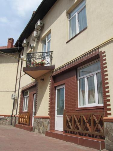 a building with a balcony with a flower box on it at Kaiser Hotel in Chernivtsi