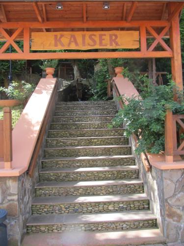 a set of stairs with a sign that reads kiaser at Kaiser Hotel in Chernivtsi