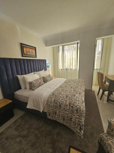 a bedroom with a large bed and a table at Al Akhawayn in Oujda