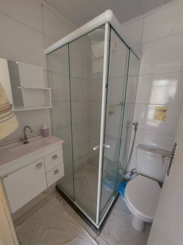 a bathroom with a glass shower and a toilet at A Casa Morro do Moreno in Vila Velha