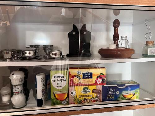 a glass cabinet with food items on a shelf at Haus Gruber - Valentina & Gabriel in der Waldheimat in Krieglach