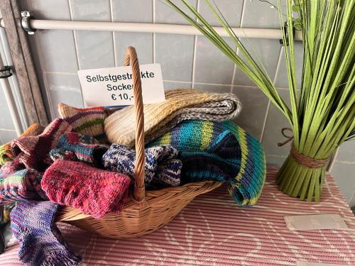 a basket filled with yarn on a table next to a plant at Haus Gruber - Valentina & Gabriel in der Waldheimat in Krieglach