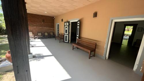 a hallway with benches and a door and a building at Honey Tree Polonnaruwa in Polonnaruwa
