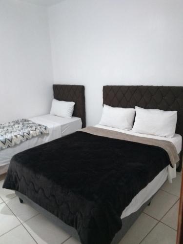 Postel nebo postele na pokoji v ubytování Hotel João Luzia