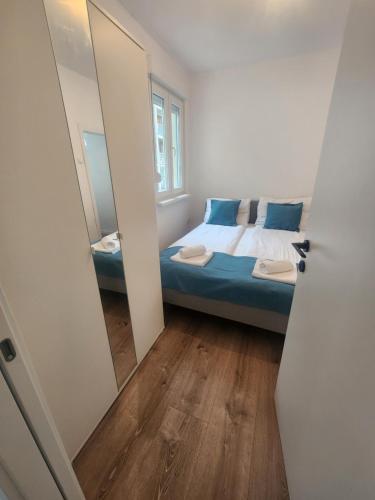 um pequeno quarto com uma cama e um espelho em Modern Cozy Suite - Vracar em Vračar (historical)