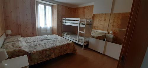 Un dormitorio con dos literas y una ventana. en Casa vacanza Lara, en Santa Brigida