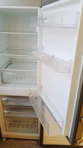 an empty refrigerator with its door open at Benny 3 na wyłączność in Toruń