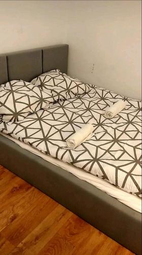 an unmade bed in a room with a wooden floor at Benny 3 na wyłączność in Toruń