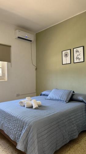 a bedroom with a bed with towels on it at La Pilar in Formosa