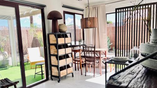 a living room with a table and chairs and a dining room at Casa Boutique Luxury Yumbo in Playa del Ingles