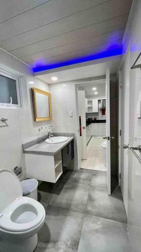 a bathroom with a white toilet and a sink at KANDI Palace, 2-Bedroom serviced Apartment in Angeles
