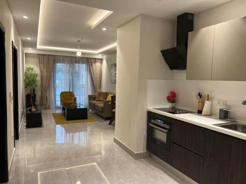 uma cozinha e uma sala de estar com um sofá em Mirage Residence Apartment Accra em Acra